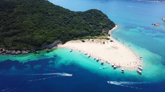 Aerial drone video from famous for Caretta caretta sea turtle haching, exotic small island of Marathonisi with white caves and sapphire sea and sandy beach , Zakynthos island, Ionian, Greece