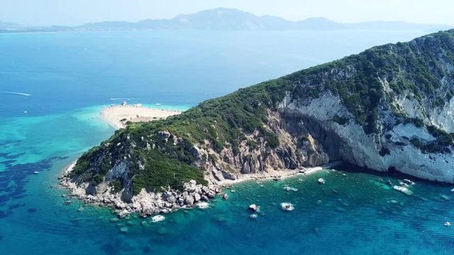 Aerial drone video from famous for Caretta caretta sea turtle haching, exotic small island of Marathonisi with white caves and sapphire sea and sandy beach , Zakynthos island, Ionian, Greece