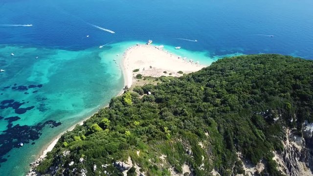 Aerial drone video from famous for Caretta caretta sea turtle haching, exotic small island of Marathonisi with white caves and sapphire sea and sandy beach , Zakynthos island, Ionian, Greece