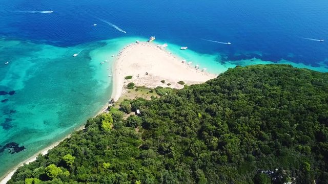 Aerial drone video from famous for Caretta caretta sea turtle haching, exotic small island of Marathonisi with white caves and sapphire sea and sandy beach , Zakynthos island, Ionian, Greece