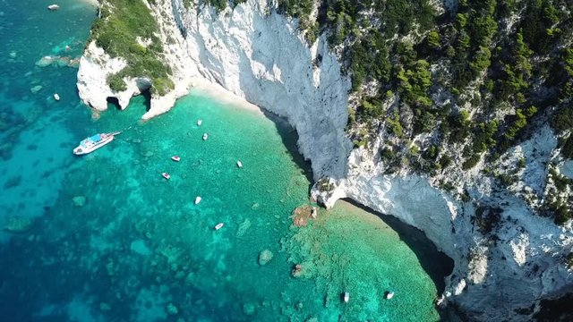 Aerial drone video from famous for Caretta caretta sea turtle haching, exotic small island of Marathonisi with white caves and sapphire sea and sandy beach , Zakynthos island, Ionian, Greece