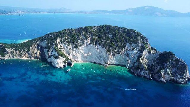 Aerial drone video from famous for Caretta caretta sea turtle haching, exotic small island of Marathonisi with white caves and sapphire sea and sandy beach , Zakynthos island, Ionian, Greece