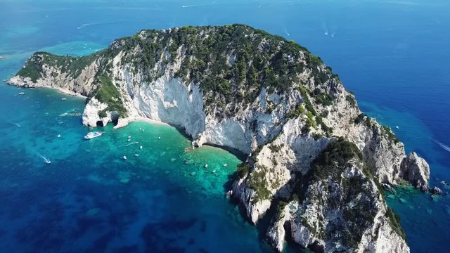 Aerial drone video from famous for Caretta caretta sea turtle haching, exotic small island of Marathonisi with white caves and sapphire sea and sandy beach , Zakynthos island, Ionian, Greece