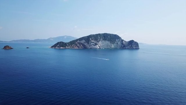Aerial drone video from famous for Caretta caretta sea turtle haching, exotic small island of Marathonisi with white caves and sapphire sea and sandy beach , Zakynthos island, Ionian, Greece