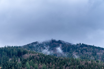 Germany, Clouds hanging over black forest nature landscape in winter season