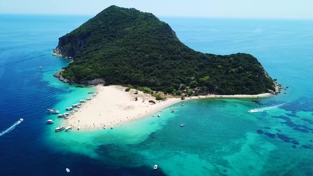 Aerial drone video of tropical island with volcanic caves and exotic emerald sea colour sandy beaches
