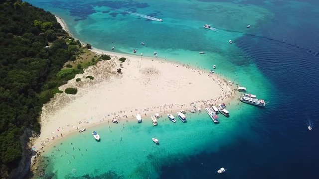 Aerial drone video from famous for Caretta caretta sea turtle haching, exotic small island of Marathonisi with white caves and sapphire sea and sandy beach , Zakynthos island, Ionian, Greece