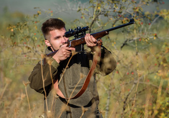 Hunting permit. Bearded hunter spend leisure hunting. Hunting equipment for professionals. Hunting is brutal masculine hobby. Man aiming target nature background. Hunter hold rifle. Aiming skills