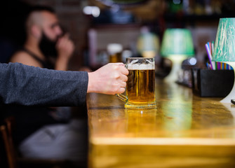 Mug filled with cold tasty beer in bar. Friday leisure tradition. Beer pub concept. Weekend lifestyle. Beer mug on bar counter defocused background. Glass with fresh lager draft beer with foam