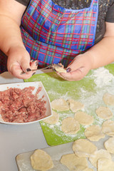 Modeling and cooking homemade dumplings woman chef at home