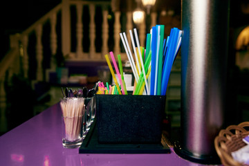 Colourful Plastic Drinking Straws.Bright multi colored straws on the bar