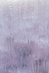 Frozen window in winter with drops and drips