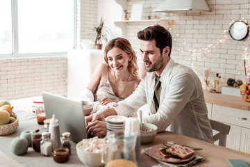Long-haired beaming pretty woman in home clothes looking happy