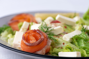 close up salad with salmon, cheese and vegetables