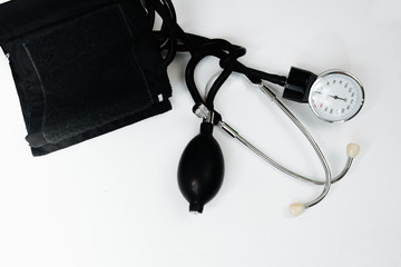 Cardiology. Tonometer and a manometer, stethoscope for diagnosis to measure of blood pressure and pulse, on a white background.