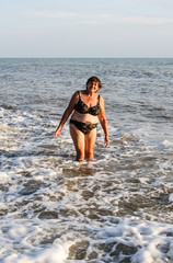 Woman in a swimsuit standing in the sea