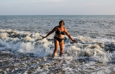 Woman in a swimsuit standing in the sea