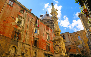 Fototapeta na wymiar Napoli, Piazza Riario Sforza square, Obelisk of San Gennaro column and old buildings and dome in background. Naples Italy 