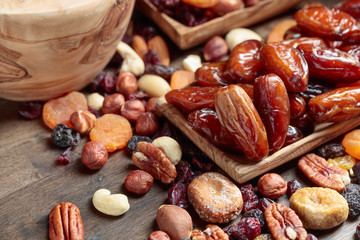 Various dried fruits and nuts in wooden dish.