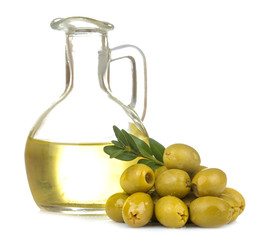 Green olives with olive oil and leaves close up on a white isolated background