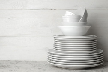 A stack of dishes. tableware on a light concrete background. dishes for serving the table. white...