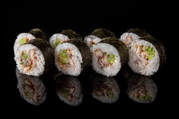Maki Sushi Rolls with smoked eel, avocado and cheese on black background. Sushi menu. Japanese food. 