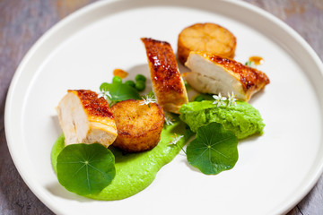 Roast chicken with fondant potatoes and pea mousse