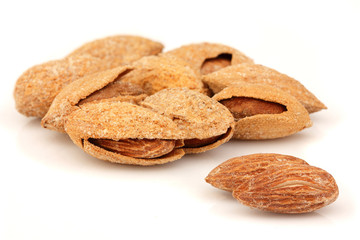 Salty almonds closeup isolated.