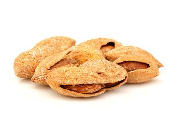 Salty almonds closeup isolated.