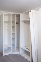 Installation of furniture indoors. Repair and assembly of light wooden wardrobe