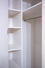 Installation of furniture indoors. Repair and assembly of light wooden wardrobe