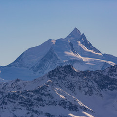 summit of Weisshorn mountain in Switzerland in winter, blue sky