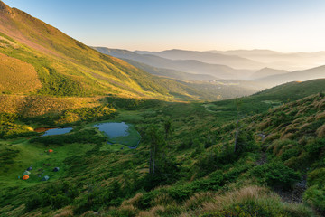 Obraz premium Tourist resort and skiing grounds Drahobrat with mountain slopes, lakes and lifts that are in the territory of the Carpathian Biosphere Reserve.