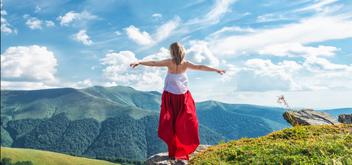 Young woman on the top of mountain