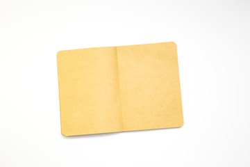 Notebook and pencil on white background. Workplace of the artist or writer. Kraft paper, top view. close-up, mockup.