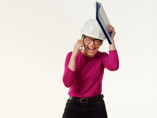 emotional girl foreman in a helmet on a white background.