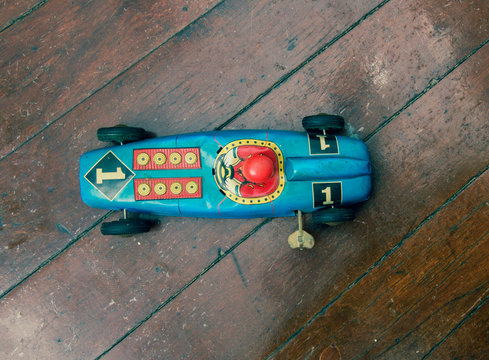 Race Car Toy On Wooden Floor From Above 