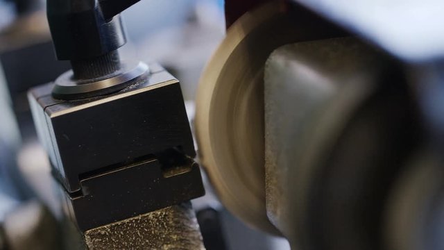 Locksmith cutting a new key with a cutting machine in the workshop