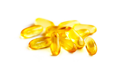 fish oil supplement capsules in selective focus isolated on white background