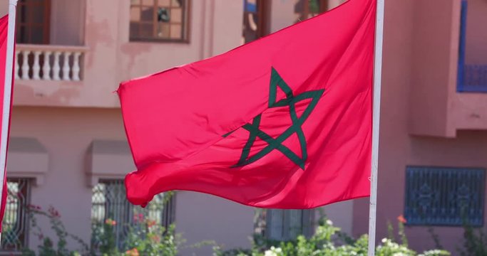 Moroccan flag waving in the wind, establishing shot with flag. Travel, exploring, off the track concept.