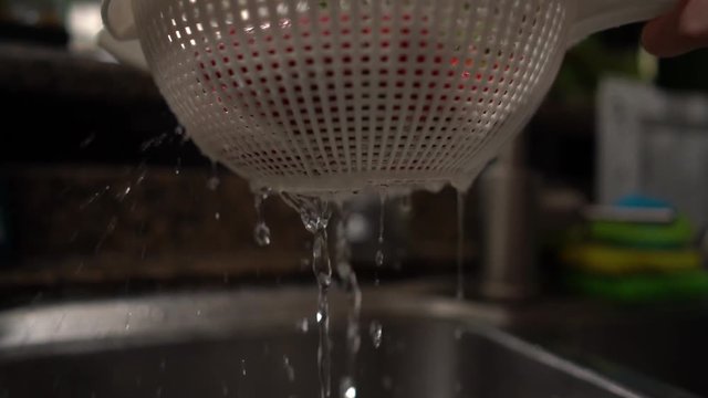 Water dropping from a strainer from washing strawberries. Shot on Batis 25mm on a Sony A7iii and slowed to 25%.