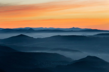 Fototapeta na wymiar Dramatic sunrise over beautiful mountain peaks. Decinsky Sneznik, Czech republic