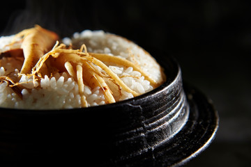 Ginseng root on steamed rice in pot 
