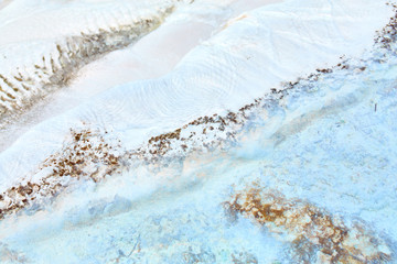 Natural travertine pools and terraces in Pamukkale in Turkey. Calcium deposits on travertine turquoise terraces at Turkey. Attractions resort town.