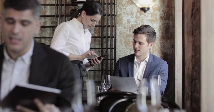 Businessman ordering in a restaurant