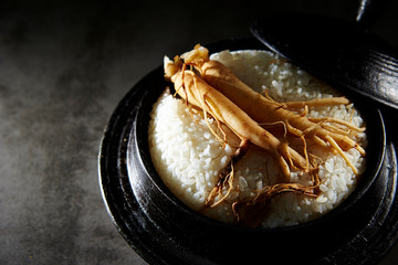 Ginseng root on steamed rice in pot 