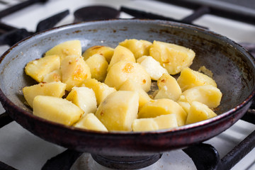 Food photo of a heated pan with cooking potato in it
