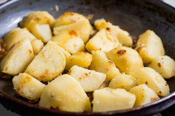 Tasty fried potato on a pan close up