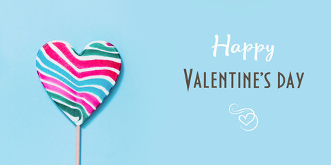 Lollipops candy as heart on blue. Valentine day concept.