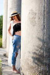Obraz premium Portrait of young redhead girl in hat on background of wall